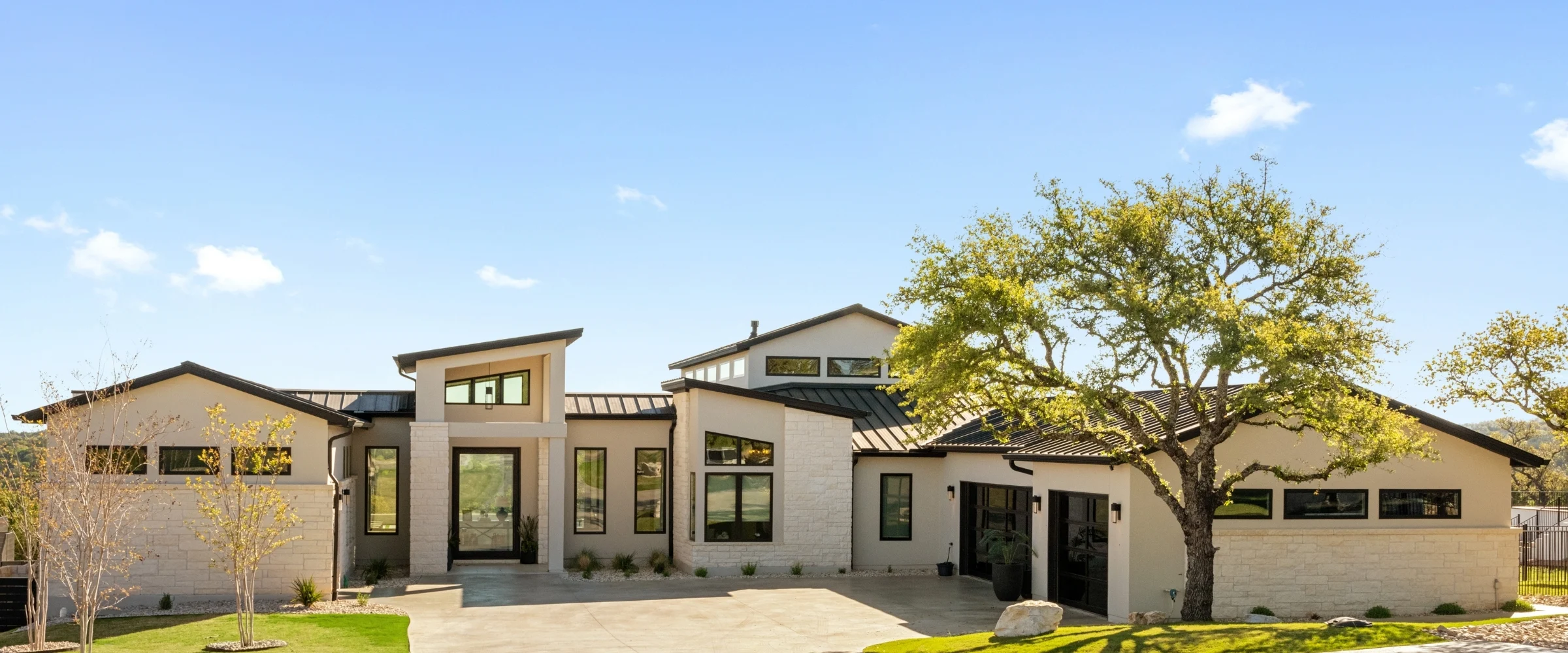 Single-storey limestone home beside a live oak